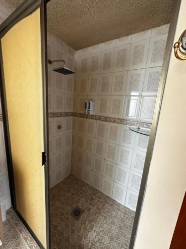 a shower with a glass door in a bathroom at CASA MARIN Pochote in Oaxaca City