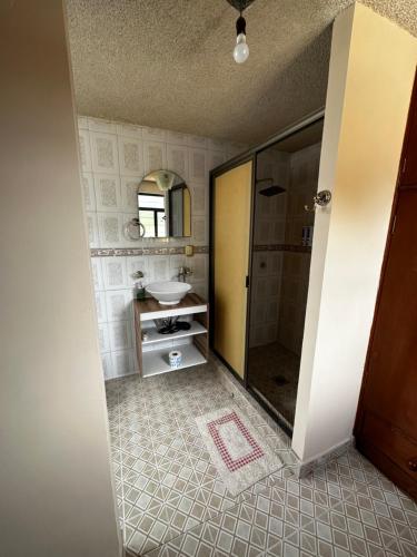 a bathroom with a shower and a sink and a mirror at CASA MARIN Pochote in Oaxaca City