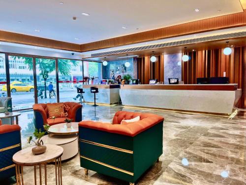 a lobby of a hotel with chairs and a bar at Slowcom┃Yuebei Hotel （Guangzhou Provincial Government) in Guangzhou