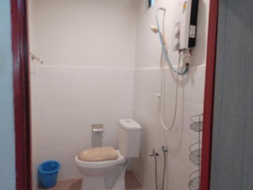 ein Bad mit einer Dusche und einem WC. in der Unterkunft Bohok Guesthouse in Pantai Cenang