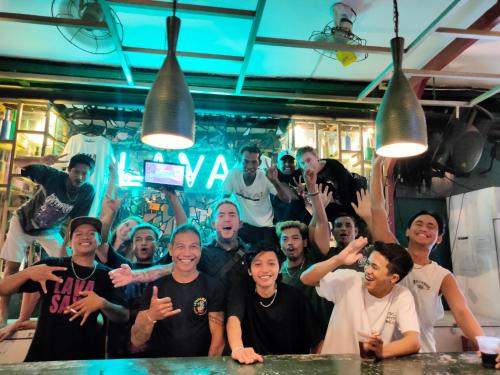 a group of people posing for a picture in a kitchen at Gili Beach Bum Hotel in Gili Trawangan