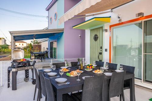 a table and chairs on a patio with a grill at Nanki Shirahama Angel in Shirahama