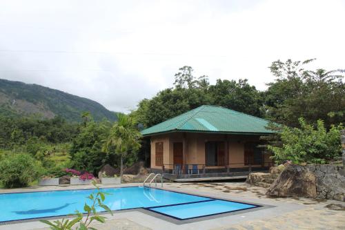 ośrodek z basenem przed budynkiem w obiekcie World's End Base Eco-Village w mieście Belihul Oya