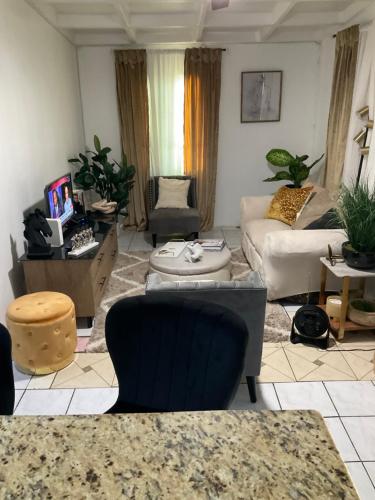 a living room with a couch and a table at Travelers Oasis in Portmore