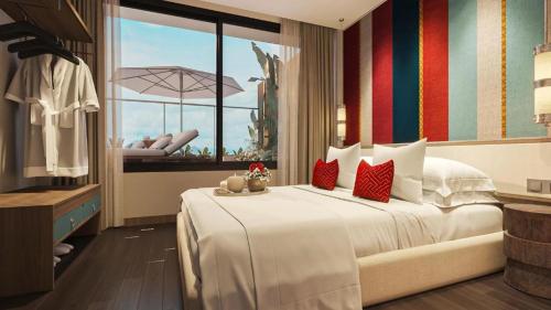 a bedroom with a large white bed and a balcony at Apec Nirvana Peace Mui Ne in Mui Ne
