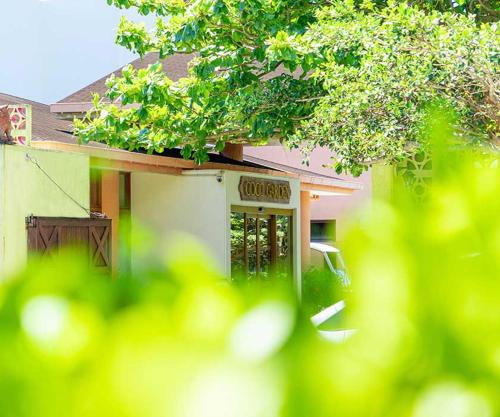 a house with a sign in front of it at Coco Garden Resort Okinawa in Uruma