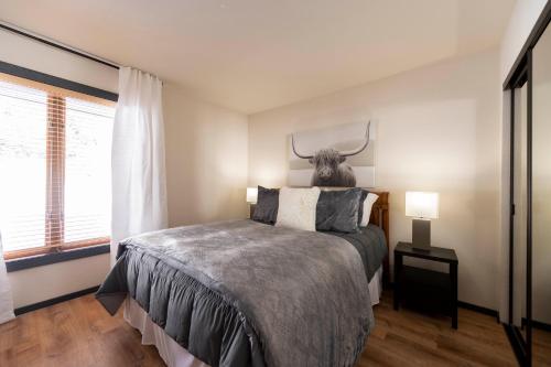 a bedroom with a bed with a antelope head on the wall at Fairway Nine 4369 - Updated Condo in the Heart of Elkhorn Resort in Sun Valley