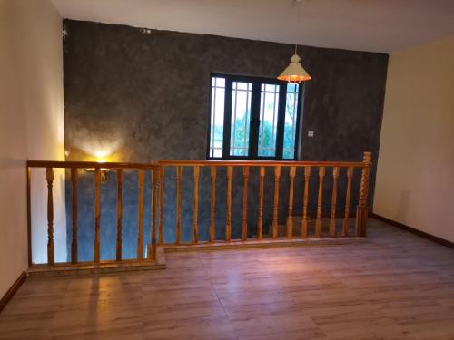 an empty room with a staircase and a window at Villa Turquoise in Calodyne