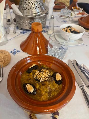 a bowl of food on top of a table at Riad Meyssane Fès in Fez