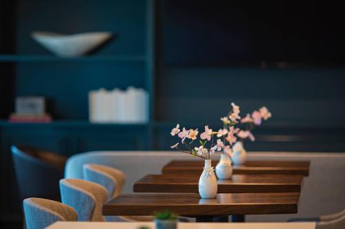 a wooden table with vases of flowers on it at JW Marriott Atlanta Buckhead in Atlanta