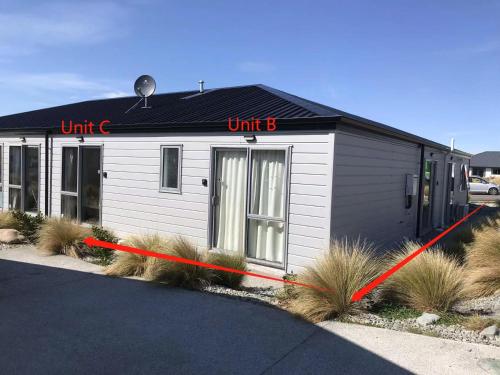 a small white building with a red tape around it at 3 Edwards in Lake Tekapo