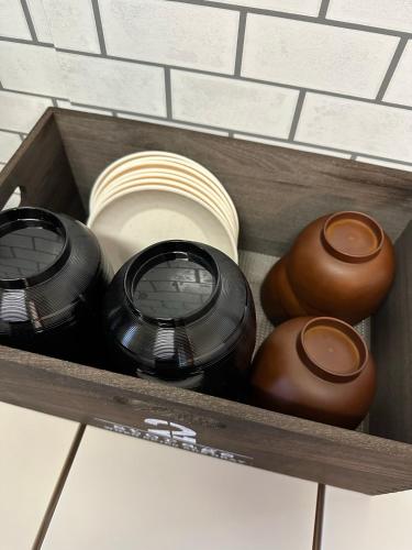 a drawer filled with pots and pans on a shelf at Independent House 沖縄VILLA YASUMIBA Okinawa Uruma in Uruma