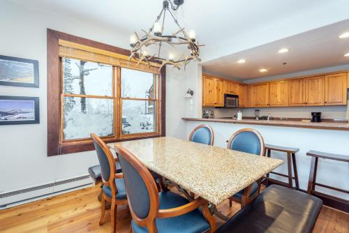 a kitchen and dining room with a table and chairs at One-Bedroom Apartment in Telluride