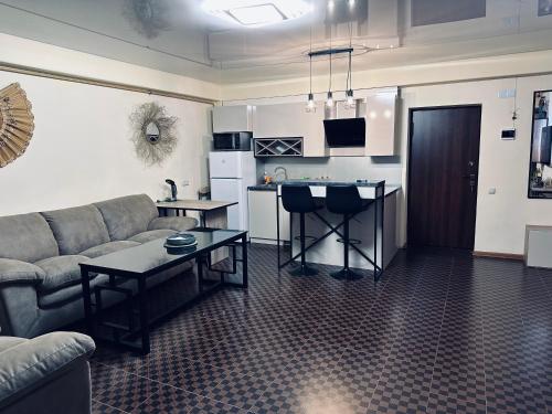 a living room with a couch and a table at Tsaghkazdor luxury apartment in Tsaghkadzor