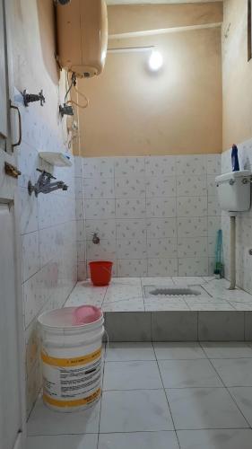 a dirty kitchen with a sink and a toilet at Anna homestay in Dirang Dzong