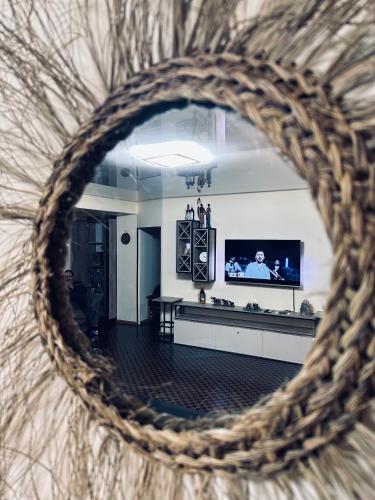 a view of a living room with a tv and a mirror at Tsaghkazdor luxury apartment in Tsaghkadzor