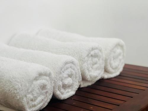 a row of white towels sitting on a wooden table at 49 White Cottage Ella in Ella