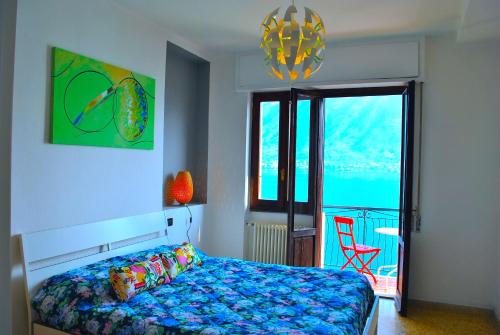 a bedroom with a bed and a view of the ocean at Belvedere - Apartment with Balcony Lake View in Sala Comacina