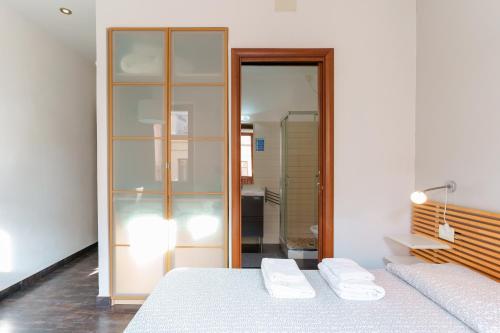 a bedroom with two beds and a glass closet at Il Palazz8 in Iglesias