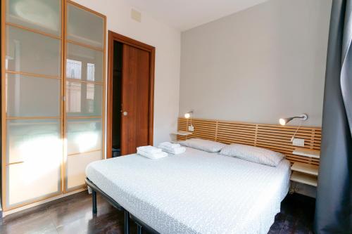 a bedroom with a bed with towels on it at Il Palazz8 in Iglesias