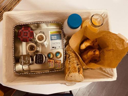 a box of food with a bag of bread and a sandwich at Yourte et son bain nordique in Fréchet-Aure