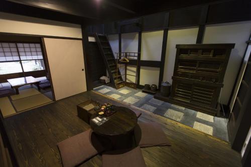 a view of a room with a table and a bed at Shirafuji-an Modern Private Machiya in Central Kyoto in Kyoto