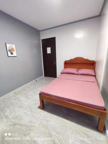 1 dormitorio con 1 cama con colchón rosa en WCW Auberge, en Moalboal