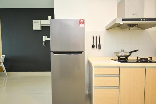 a stainless steel refrigerator in a kitchen at 1Medini Theme Suite by Nest Home【LEGOLAND】 in Nusajaya