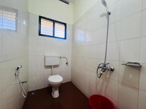 a bathroom with a toilet and a shower at Hotel Sunday - Townhouse Club Airport Trivandrum in Trivandrum
