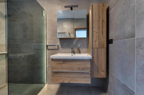 a bathroom with a sink and a shower at Villa Rosemary -semi-detached villa with a pool and a panoramic view, close to a sandy beach - by TRAVELER tourist agency Krk in Risika
