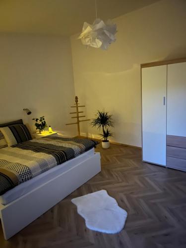 a bedroom with a bed and a white closet at Apartmán NIKLAN in Rožnov pod Radhoštěm