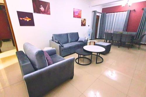 a living room with a couch and a table at Les Alizés Appartement meublé 3 in Toamasina