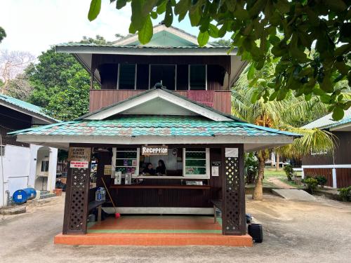 a building with a kiosk in front of it at Mama's Chalet Pulau Perhentian Besar in Perhentian Island