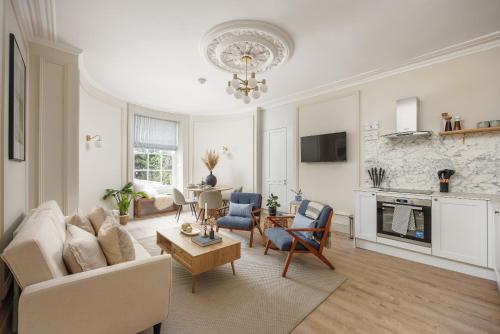 a living room with a couch and a table at NEW 2023 Central 2bed Apartment Sleeps 6 with garden in Plymouth