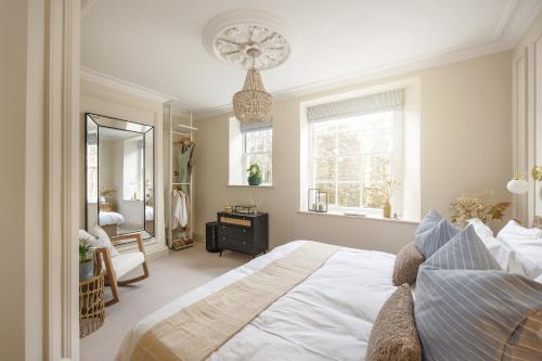 a bedroom with a large bed and a mirror at NEW 2023 Central 2bed Apartment Sleeps 6 with garden in Plymouth