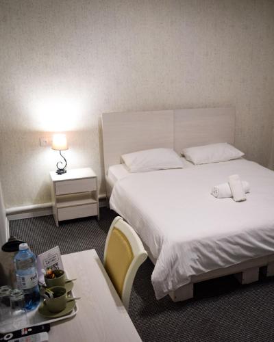a hotel room with two beds and a table at Hotel "CONTINENT" halal in Karagandy