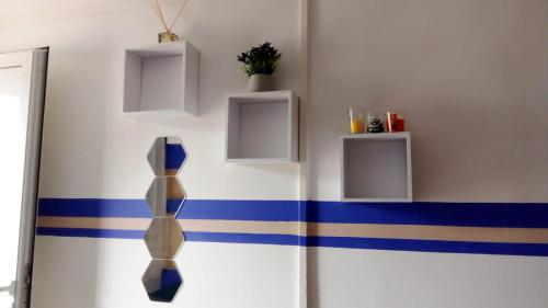 a room with blue and white stripes on a wall at Le Caferoom Club in Tsingoni