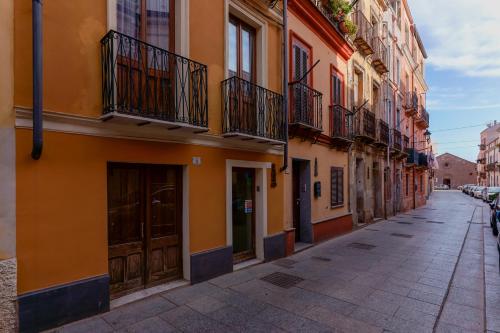 an empty street in a city with buildings at Il Palazz8 in Iglesias
