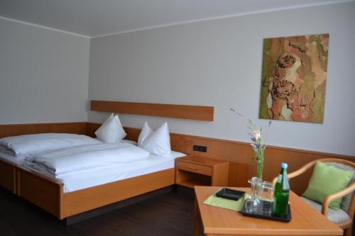 a hotel room with a bed and a table at Aparthotel Sprendlingen in Sprendlingen