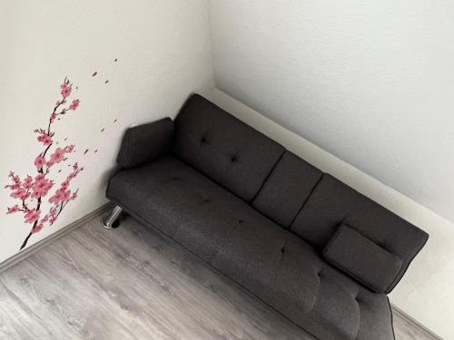 a brown couch in a corner of a room at Las Vegas by D&J Apartment‘s in Oberhausen