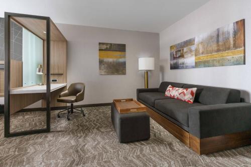 a living room with a couch and a desk at SpringHill Suites by Marriott Philadelphia West Chester/Exton in Exton