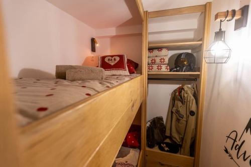 a small bedroom with a bunk bed and a closet at Le Rioumajou 3 in Saint-Lary-Soulan