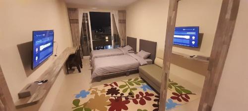 a small living room with a couch and a television at SleepRest @ NTC in Nagoya