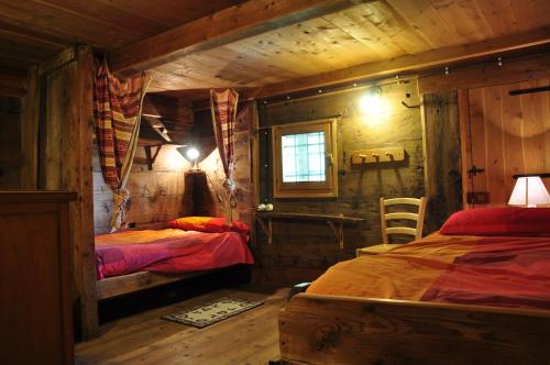 מיטה או מיטות בחדר ב-Baita Prato Della Croce