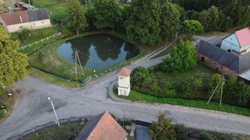 an aerial view of a small pond in a town at Mieszkanie na wsi in Trzebiel