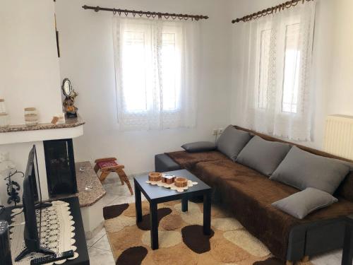 a living room with a couch and a coffee table at Vicky’s home in Kalabaka