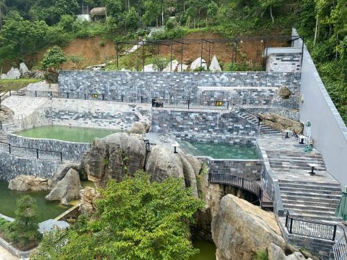 um anfiteatro com uma ponte e algumas rochas em Homestay ties em Ha Giang