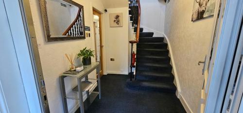 a hallway with a stairway with a stair case at Inverour Guest House in Spean Bridge