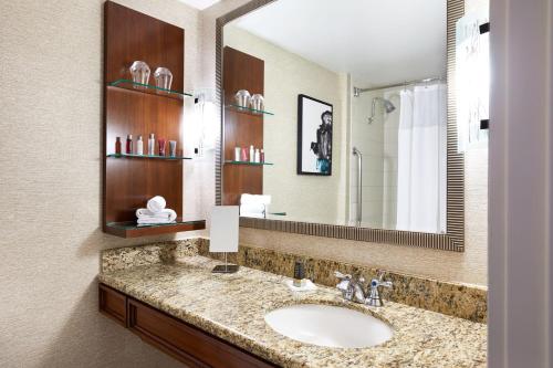 a bathroom with a sink and a mirror at Delta Hotels by Marriott Phoenix Mesa in Mesa