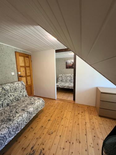 a bedroom with a bed and a wooden floor at Willa Zacisze Karpacz in Karpacz